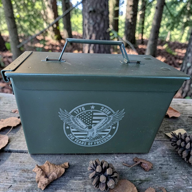 Green metal ammo can with a logo on a wooden surface in a forest setting