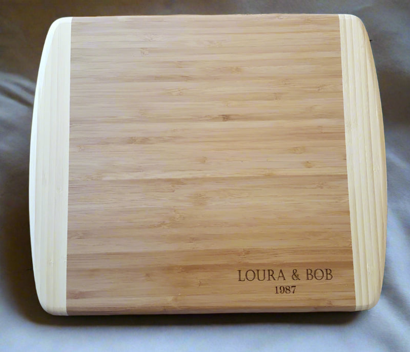 Wooden cutting board with engraved text on a marble surface