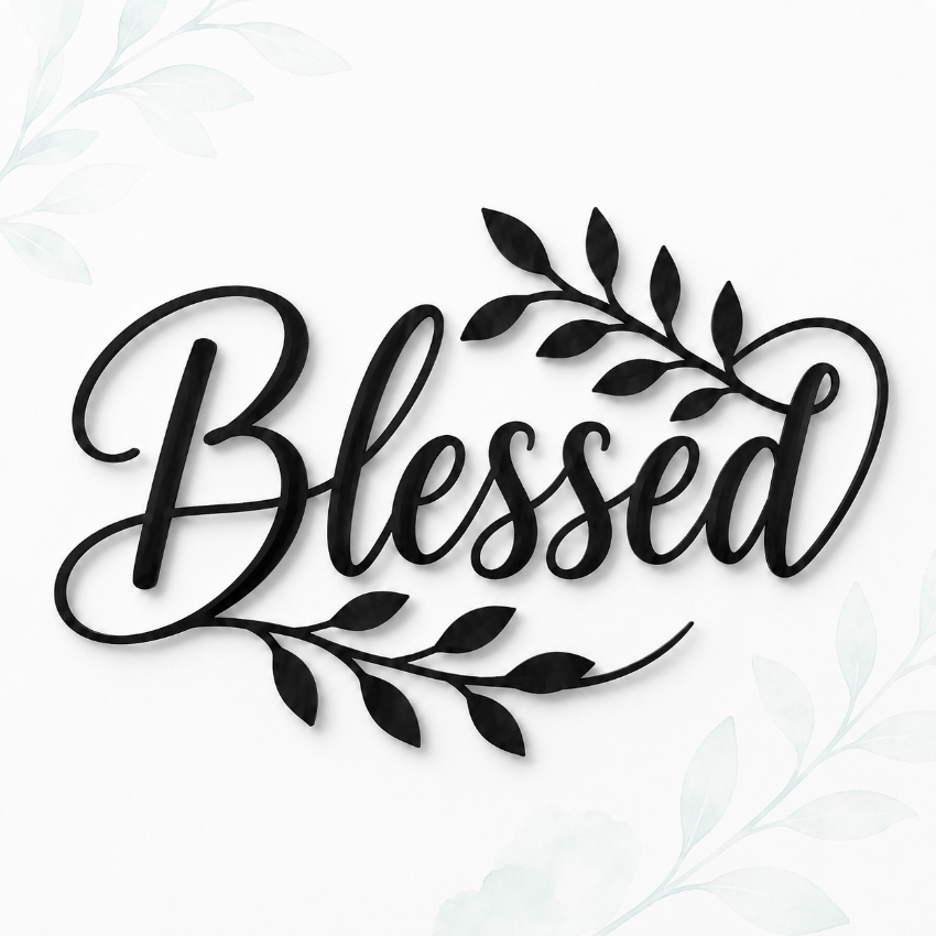 Black script lettering reading 'Blessed' with decorative leafy branches, shown on a white background with faint pale green floral corner accents.