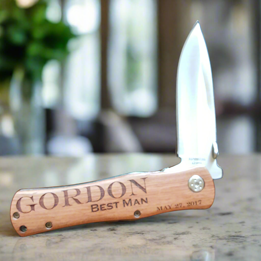 Pocket knife with wooden handle on a dark quilted surface