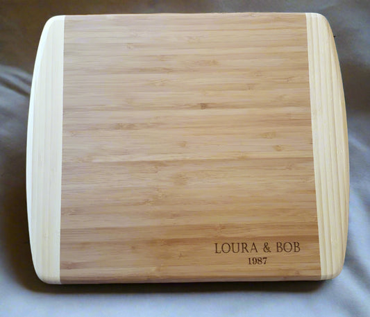 Wooden cutting board with engraved text on a marble surface