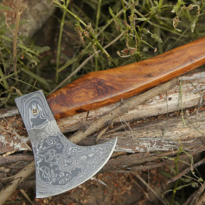 Axes with wooden handles on a natural background