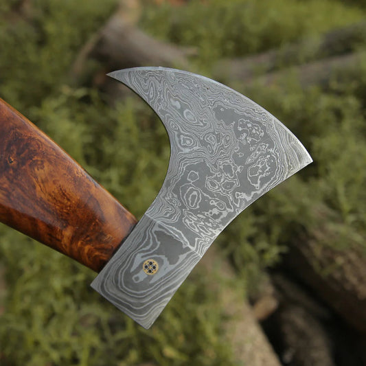 Decorative axe with a detailed blade on a natural background