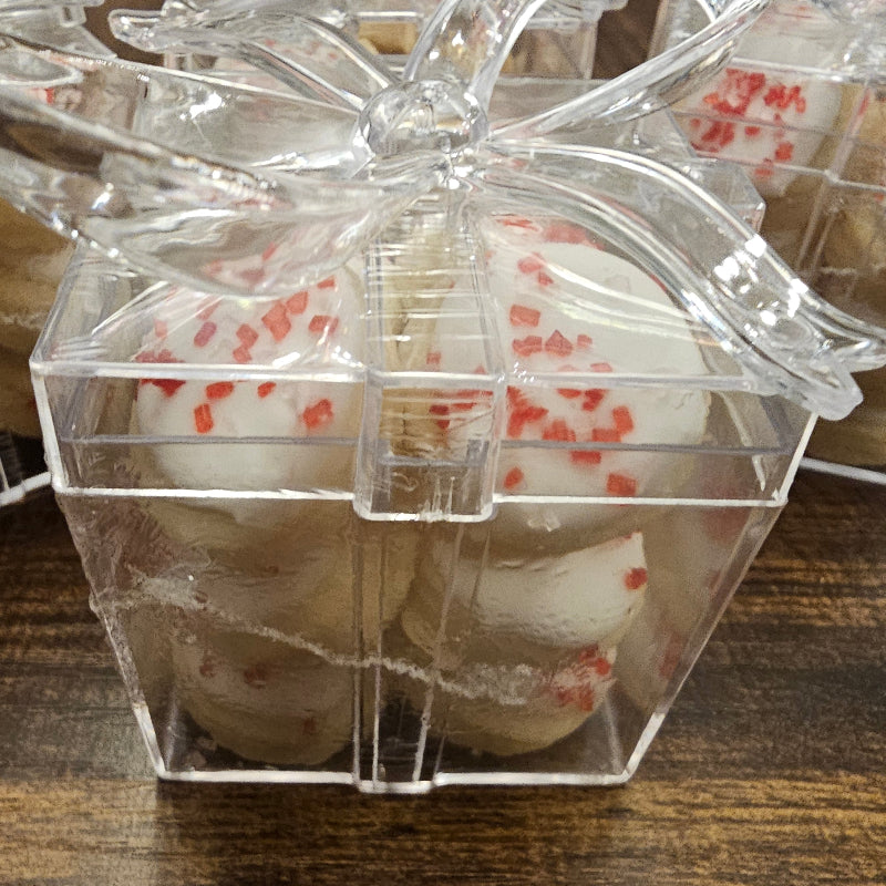 Clear plastic packaging containing small round decorated sugar cookies