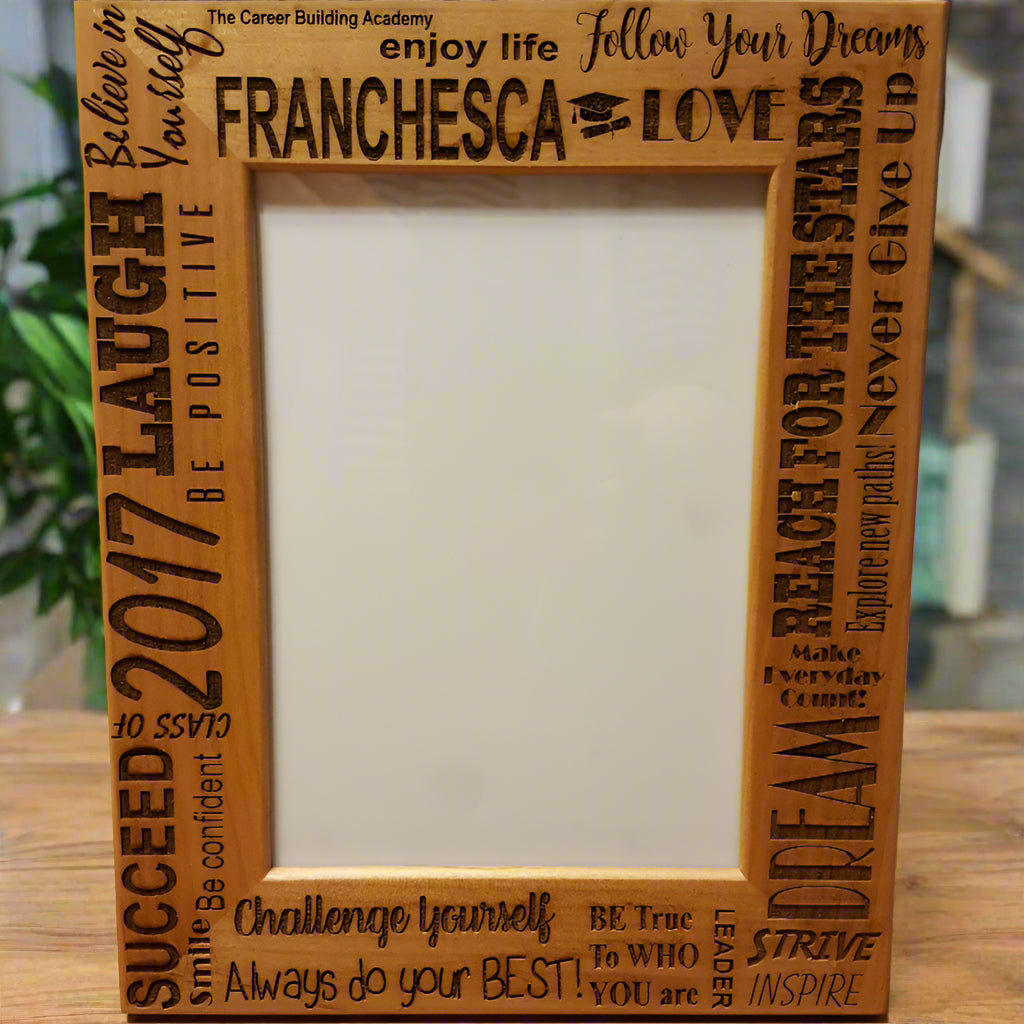 Wooden photo frame with engraved text on a wooden surface