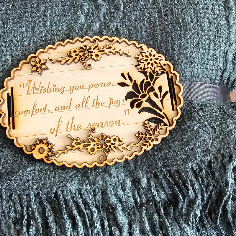Decorative wooden tag with text on a textured fabric background