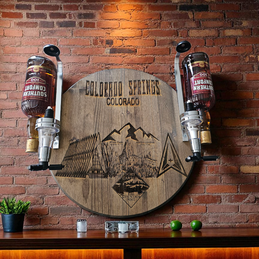 Wooden sign with mountain design and 'Colorado Springs, Colorado' text on a brick wall.