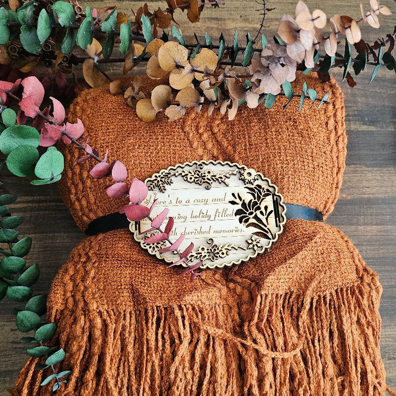 Orange textured fabric with decorative elements on a wooden surface