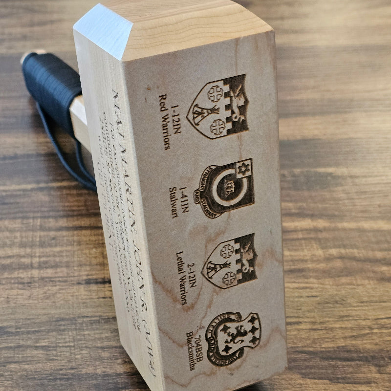 Wooden Thor Hammer with engraved designs on a wooden surface